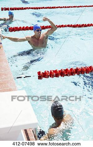 Stock Photo - Swimmer celebrating in pool. Fotosearch
