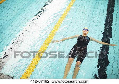 Swimmer floating in pool View Large Photo Image Stock Image - Swimmer floating in pool. Fotosearch