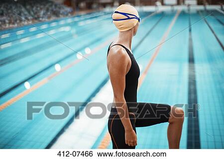 Swimmer standing at poolside View Large Photo Image Stock Photograph - Swimmer standing at poolside. Fotosearch