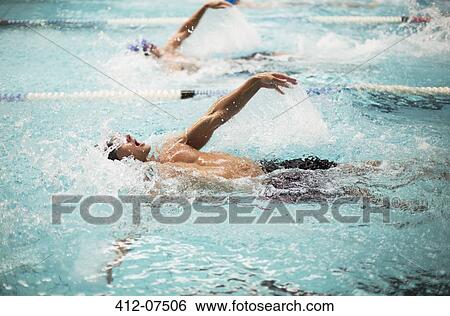 Stock Photograph - Swimmers racing in pool. Fotosearch
