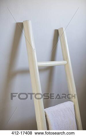Towel hanging on ladder in bathroom View Large Photo Image Stock Photo - Towel hanging on ladder in bathroom. Fotosearch