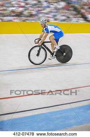 Stock Photo - Track cyclist riding in velodrome. Fotosearch