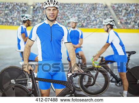 Stock Photo - Track cyclists standing in velodrome. Fotosearch