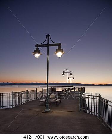 Stock Image - Tranquil pier at sunset. Fotosearch