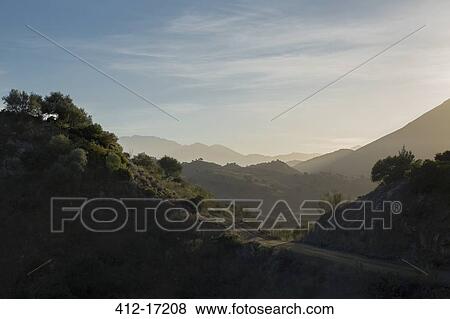 Stock Photo - View of sunny mountain landscape. Fotosearch