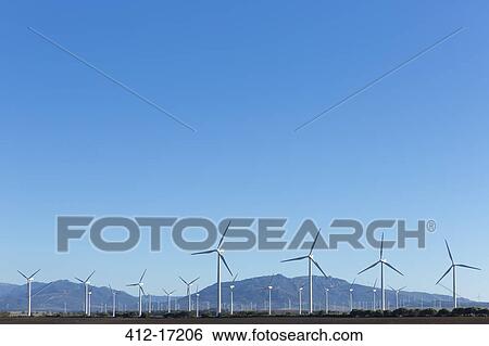 Stock Photograph - Wind farm under blue sky. Fotosearch