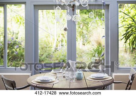 Wooden table in sunroom View Large Photo Image Stock Photo - Wooden table in sunroom. Fotosearch