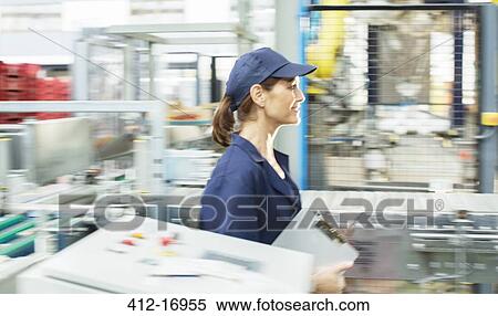 Worker with clipboard walking in food processing plant View Large Photo Image Stock Photography - Worker with clipboard walking in food processing plant. Fotosearch