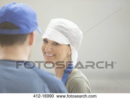 Workers talking in food processing plant View Large Photo Image Stock Image - Workers talking in food processing plant. Fotosearch