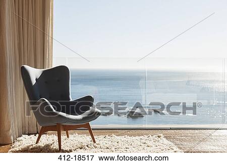 Chair in sunny window overlooking ocean View Large Photo Image Stock Photo - Chair in sunny window overlooking ocean. Fotosearch