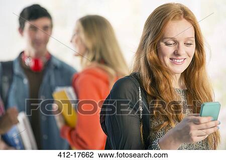 College student text messaging with cell phone View Large Photo Image Stock Image - College student text messaging with cell phone. Fotosearch