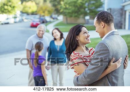 Stock Photography - Couple hugging in driveway. Fotosearch