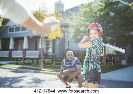 Family playing baseball in street View Large Photo Image Picture - Family playing baseball in street. Fotosearch