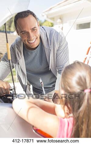Father and daughter fixing car engine View Large Photo Image Stock Image - Father and daughter fixing car engine. Fotosearch