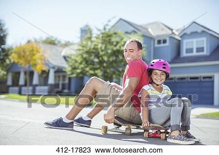 Father and daughter sitting on skateboard View Large Photo Image Stock Image - Father and daughter sitting on skateboard. Fotosearch