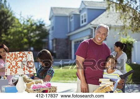 Stock Photo - Grandfather and granddaughter at yard sale. Fotosearch