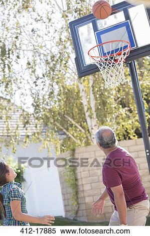 Grandfather and granddaughter playing basketball View Large Photo Image Stock Photography - Grandfather and granddaughter playing basketball. Fotosearch