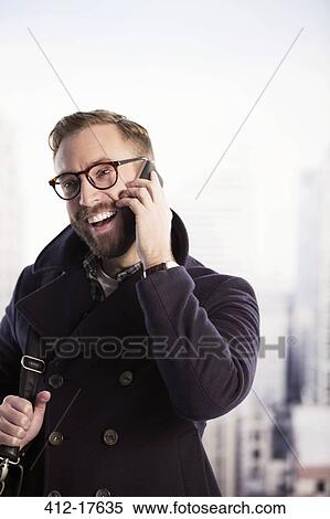 Stock Photography - Happy businessman talking on cell phone. Fotosearch