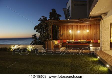 Stock Photo - Illuminated patio at night. Fotosearch