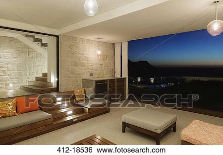 Luxury living room overlooking ocean at night View Large Photo Image Stock Photograph - Luxury living room overlooking ocean at night. Fotosearch