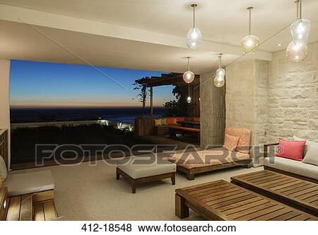 Stock Photo - Luxury patio overlooking ocean at night. Fotosearch