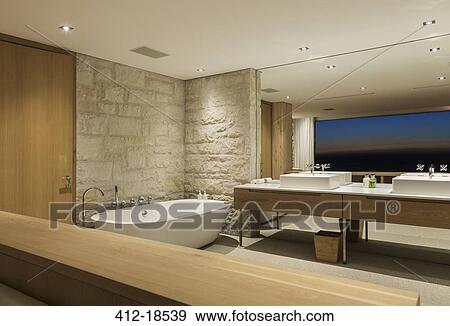 Modern bathroom with soaking tub at night View Large Photo Image Stock Photo - Modern bathroom with soaking tub at night. Fotosearch