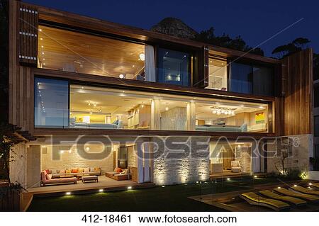 Modern house illuminated at night View Large Photo Image Stock Image - Modern house illuminated at night. Fotosearch