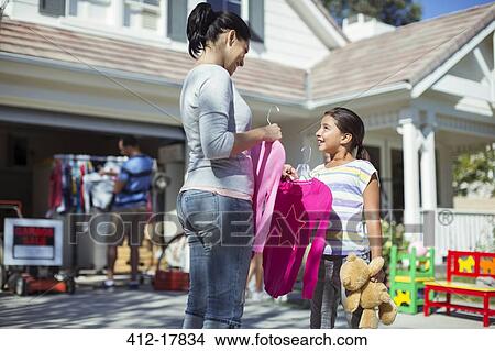 Mother and daughter shopping for clothes at yard sale View Large Photo Image Picture - Mother and daughter shopping for clothes at yard sale. Fotosearch