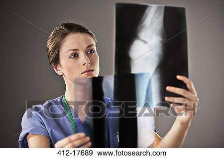 Nurse examining x-rays View Large Photo Image Stock Photo - Nurse examining x-rays. Fotosearch