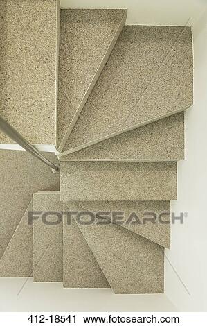 Stock Image - Overhead view of modern spiral staircase. Fotosearch
