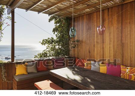Stock Photo - Patio bench overlooking ocean. Fotosearch