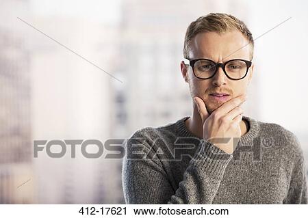 Pensive businessman with hand on chin View Large Photo Image Stock Image - Pensive businessman with hand on chin. Fotosearch