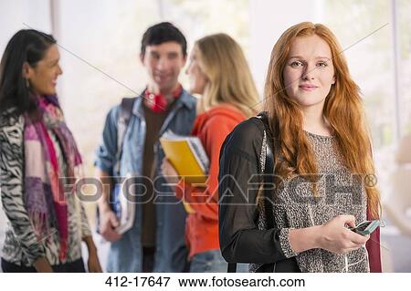 Stock Photo - Portrait of college student with cell phone. Fotosearch