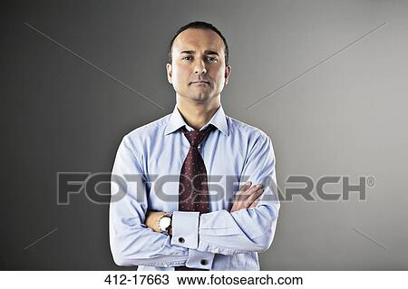 Portrait of confident businessman with arms crossed View Large Photo Image Stock Image - Portrait of confident businessman with arms crossed. Fotosearch