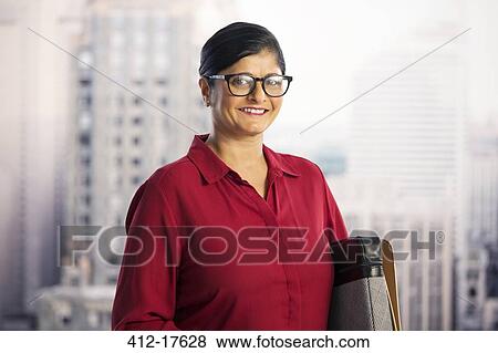 Stock Photo - Portrait of confident businesswoman in urban window. Fotosearch