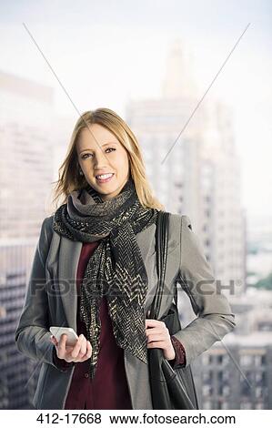 Stock Photo - Portrait of confident businesswoman in urban window. Fotosearch