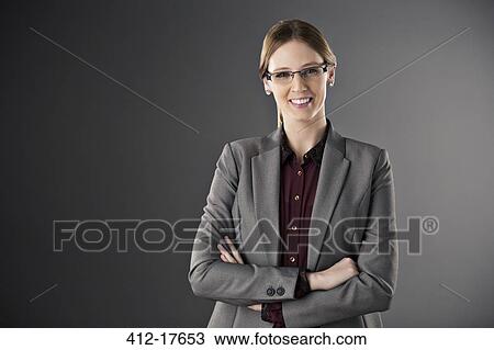 Stock Image - Portrait of confident businesswoman with arms crossed. Fotosearch