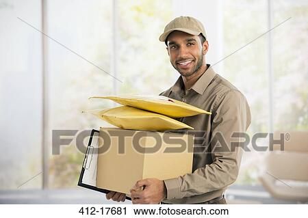 Portrait of confident deliveryman View Large Photo Image Stock Image - Portrait of confident deliveryman. Fotosearch