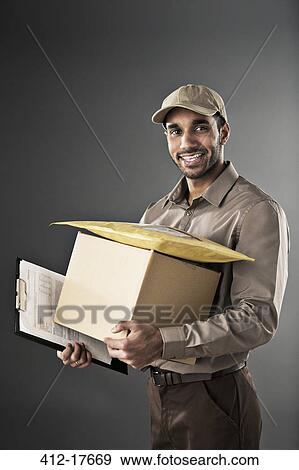 Portrait of confident deliveryman View Large Photo Image Stock Photo - Portrait of confident deliveryman. Fotosearch