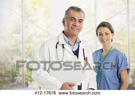 Portrait of confident doctor and nurse View Large Photo Image Stock Photograph - Portrait of confident doctor and nurse. Fotosearch