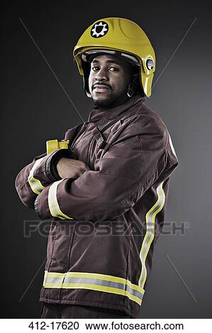 Stock Image - Portrait of confident fireman. Fotosearch