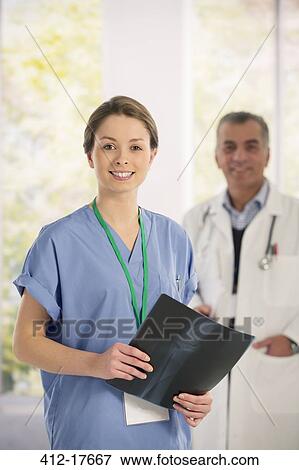 Portrait of confident nurse with x-ray View Large Photo Image Stock Photo - Portrait of confident nurse with x-ray. Fotosearch