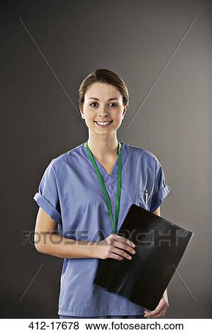 Stock Photo - Portrait of confident nurse with x-ray. Fotosearch