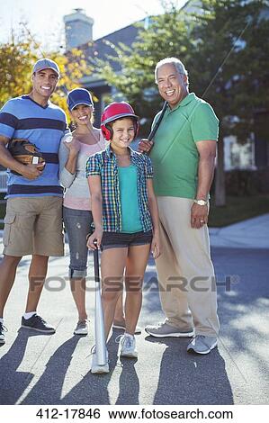 Portrait of happy multi-generation family playing baseball in street View Large Photo Image Stock Photograph - Portrait of happy multi-generation family playing baseball in street. Fotosearch