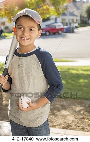 Stock Image - Portrait of smiling boy with baseball and bat. Fotosearch