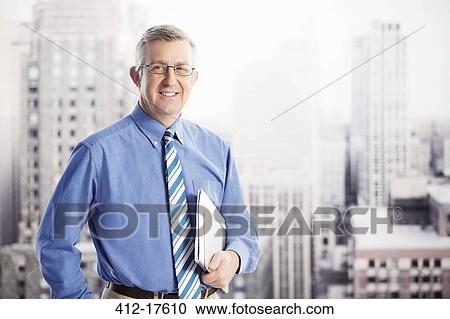 Portrait of smiling businessman in urban window View Large Photo Image Stock Image - Portrait of smiling businessman in urban window. Fotosearch