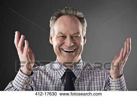 Portrait of smiling businessman gesturing View Large Photo Image Stock Image - Portrait of smiling businessman gesturing. Fotosearch