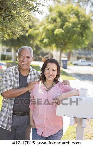 Portrait of smiling couple at mailbox View Large Photo Image Stock Photography - Portrait of smiling couple at mailbox. Fotosearch