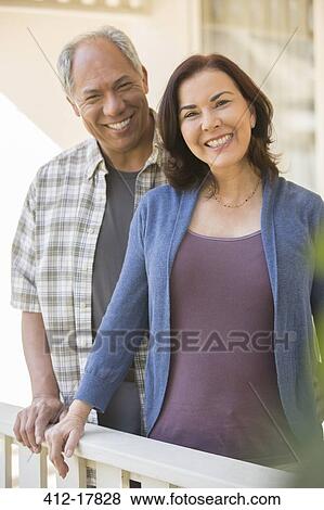 Portrait of smiling couple on porch View Large Photo Image Stock Photo - Portrait of smiling couple on porch. Fotosearch