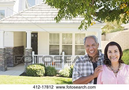 Portrait of smiling couple outside house View Large Photo Image Stock Image - Portrait of smiling couple outside house. Fotosearch